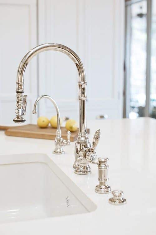 A fancy silver tap fixture used for a kitchen sink